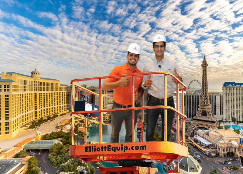 Two participants soar over Las Vegas on this Elliott Equipment platform lift -- or at least, that's how the finished photo looked from this Las Vegas Green Screen Photo Booth.