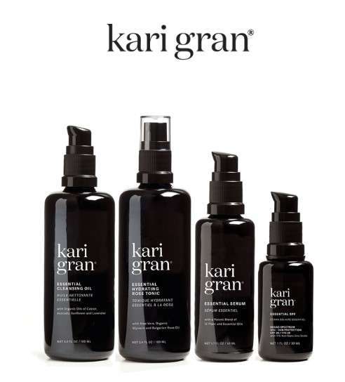 A collection of kari gran skincare products found in Meridian, Idaho, in uniform black bottles with white labels.