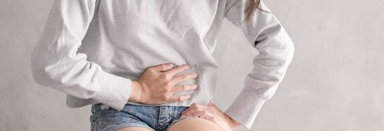 Woman suffers from stomach pain due to IBS digestive issues