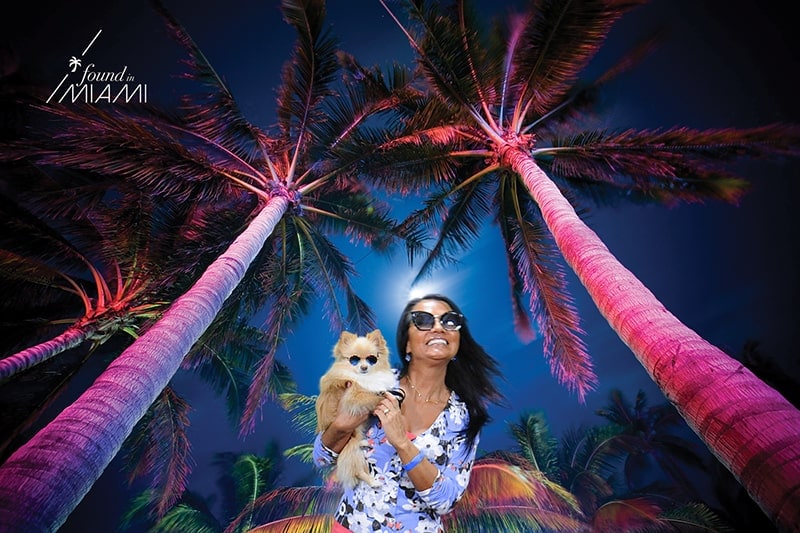 A participant "poses" under the palm trees for this Miami green screen photography experience.