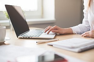 management consultancy job candidate using laptop in job search