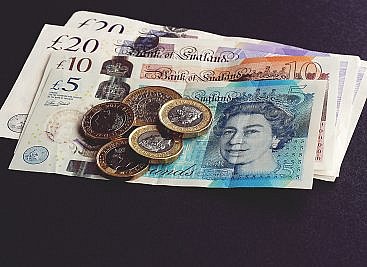 management consultant salary review shown as coins and notes