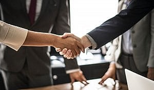 shaking hands at the end of a business meeting