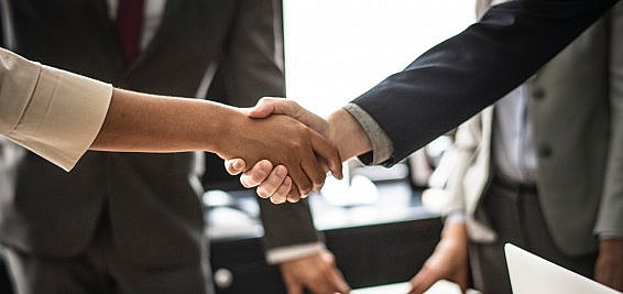 shaking hands at the end of a business meeting