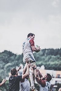 rugby player representing recruiter helped by both client and candidate