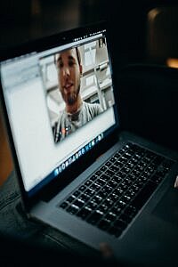 Laptop screen showing a video interview or meeting in progress