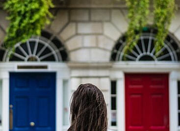 job candidate standing in from of two doors