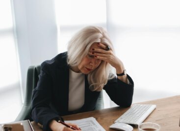 Woman at a desk reviewing a CV