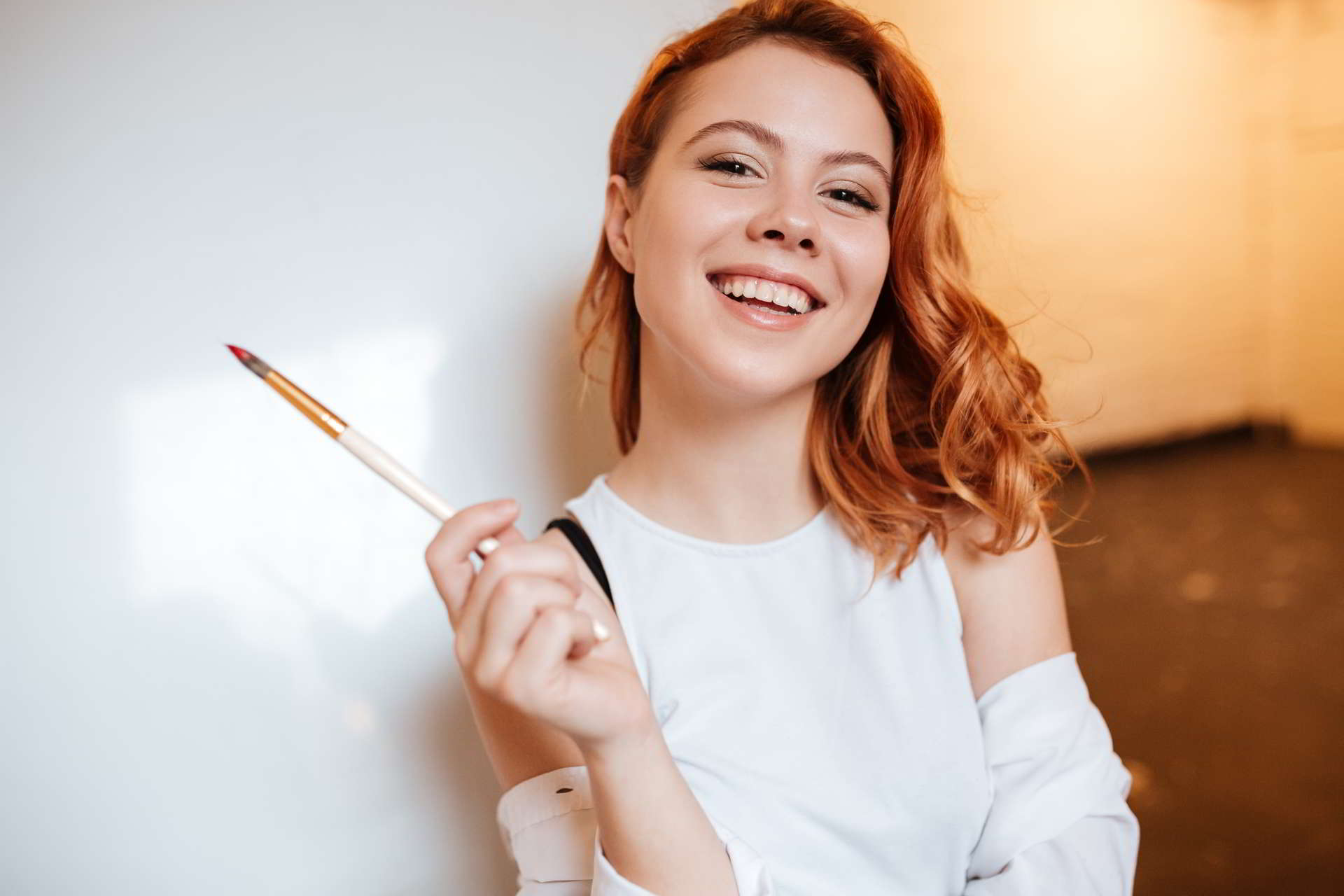 image happy attractive young woman painter with hair standing over blank canvas