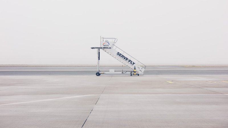 A photo of an airplane staircase on wheels parked on a runway as a metaphor for a startup runway