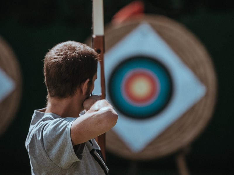 a man taking aim at a bulls-eye as a metaphor for a target market