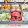 Gelato-vs-Ice-Cream-Isnt-it-the-same-thing-featured-image-200x600w-selection-of-gelatos-lined-up-in-large-display-trays-frosted-fusions