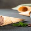 The-Perfect-Brew-Homemade-Coffee-Ice-Cream-featured-image-200x598w-coffee-ice-cream-in-a-cone-plus-glass-filled-with-coffee-beans-and-some-fresh-leaves-frosted-fusions