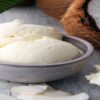 Homemade-Coconut-Ice-Cream-Recipe-featured-image-200x600w-dish-of-coconut-ice-cream-with-coconut-shavings-and-half-a-coconut-to-the-side-frosted-fusions