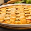 Spiced-Apple-Homemade-Ice-Cream-A-Twist-on-a-Classic-Pie-Favourite-featured-image-200x600w-latticed-apple-pie-with-fresh-apples-and-cinnamon-sticks-scattered-frosted-fusions