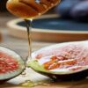 Homemade-Fig-And-Honey-Ice-Cream-Recipe-featured-image-cropped-200x620w-fig-sliced-in-half-with-honey-drizzling-over-the-fig-jar-of-honey-and-figs-in-background-frosted-fusions