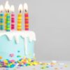 Homemade-Birthday-Cake-Ice-Cream-Recipe-featured-image-207x620w-decorated-birthday-cake-with-icing-and-sprinkles-around-the-bottom-and-several-candles-lit-frosted-fusions