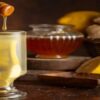 A-Not-So-Hot-Toddy-–-Homemade-Honey-Lemon-Ginger-Ice-Cream-featured-image-207x620w-glass-of-hot-toddy-with-fresh-lemon-honey-and-ginger-to-the-side-Frosted-Fusions