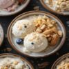 Vegan Desserts - Healthy & Unique Plant-Based Ice Cream Recipes featured image 637x1920w top view of bowl of vegan ice cream garnished with nuts fresh fruit Frosted Fusions