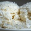 Why Is My Ice Cream Grainy Common Causes & Easy Fixes Featured image 637x1920w Bowl of ice cream with two scoops covered in ice crystals with grainy testure Frosted Fusions
