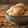 5-Delicious-Autumn-Inspired-Ice-Cream-Recipes-That-Taste-Like-A-Hug-Image-6-Bowl-of-autumn-inspired-ice-cream-scoops-on-rustic-table-with-fall-leaves-Frosted-Fusions