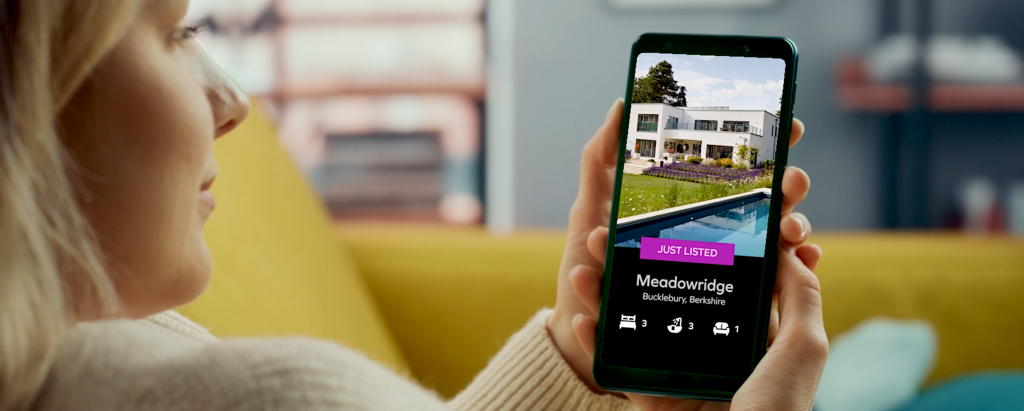 digital marketing for estate agents - Vidibar An image of woman watching real estate video on mobile highlighting importance of digital marketing for estate agents.