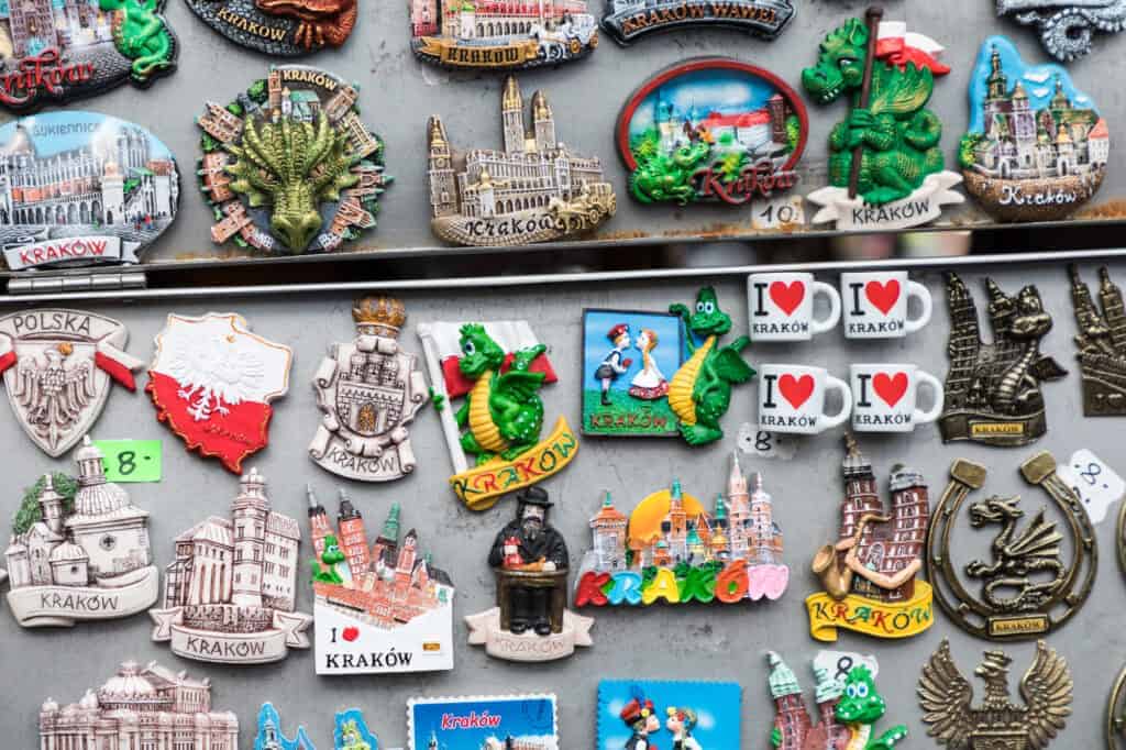 A display of colorful Krak&oacute;w-themed fridge magnets featuring city landmarks, dragons, hearts, and Poland-related designs&mdash;perfect Polish souvenirs and unique things to buy in Poland.