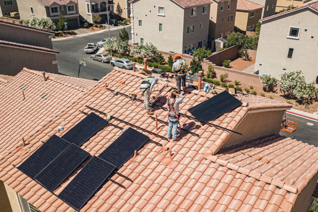 Solar panels being installed on a house's roof.