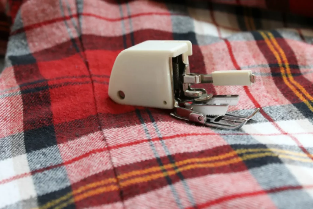 A Walking Foot for a Sewing Machine, lying on a piece of flanel fabric