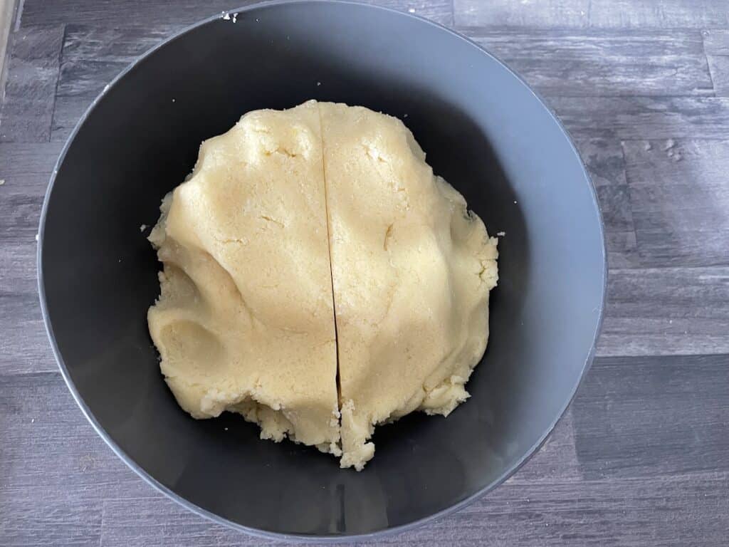 Divide the Polish plum cake dough into two parts.