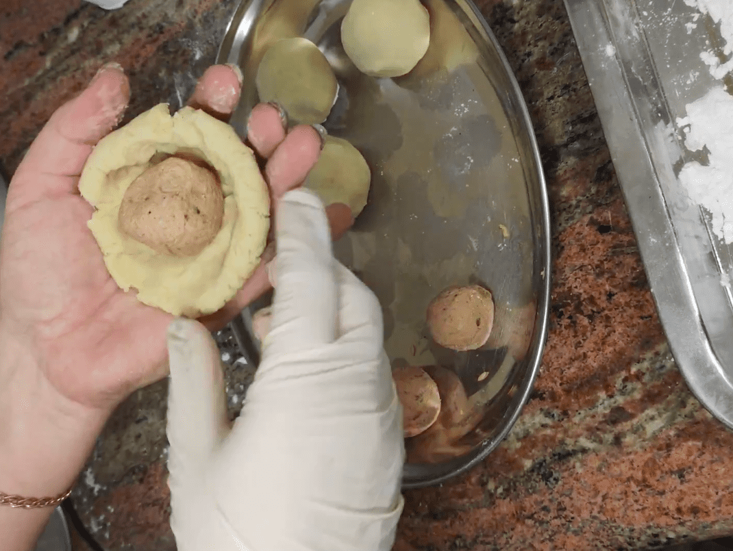 Add the minced meat balls to the dough.