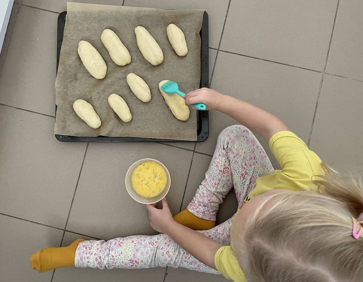 Brush the Polish hot dog buns with egg wash.