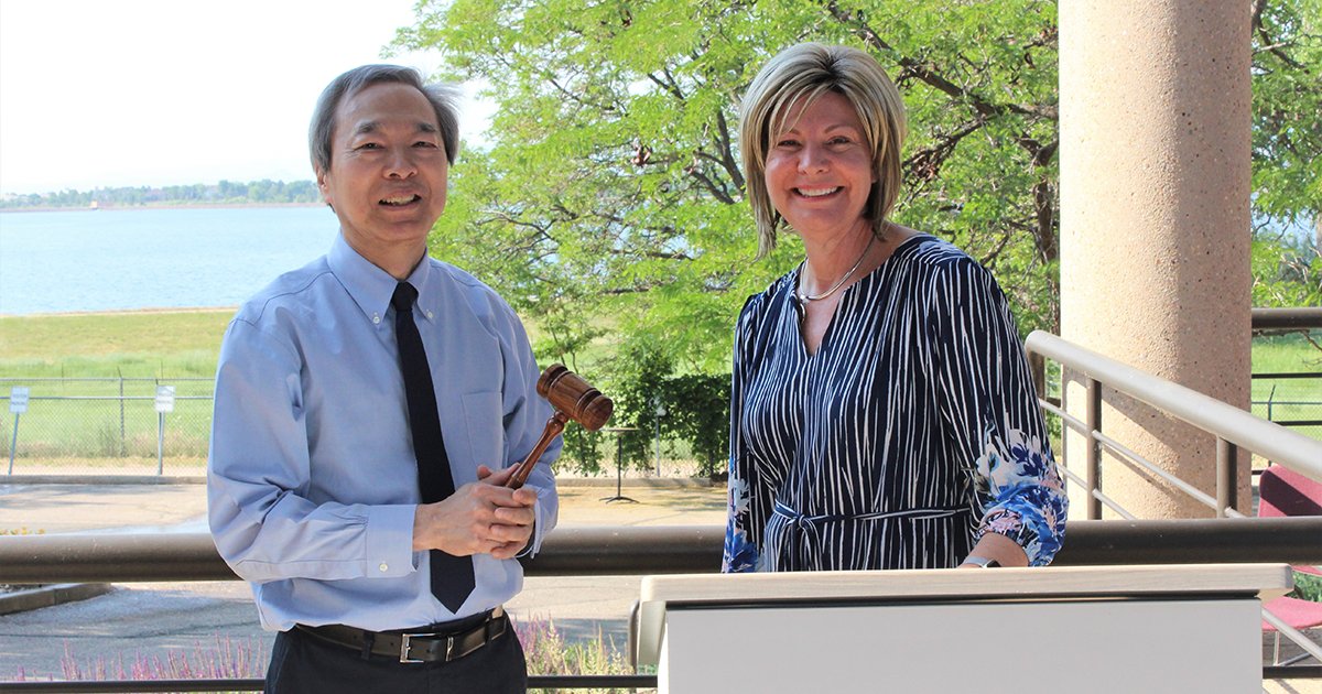 AWWA Immediate Past President Melissa Elliott passes the gavel to AWWA President Dr. Chi Ho Sham. (Photo Credit: AWWA)