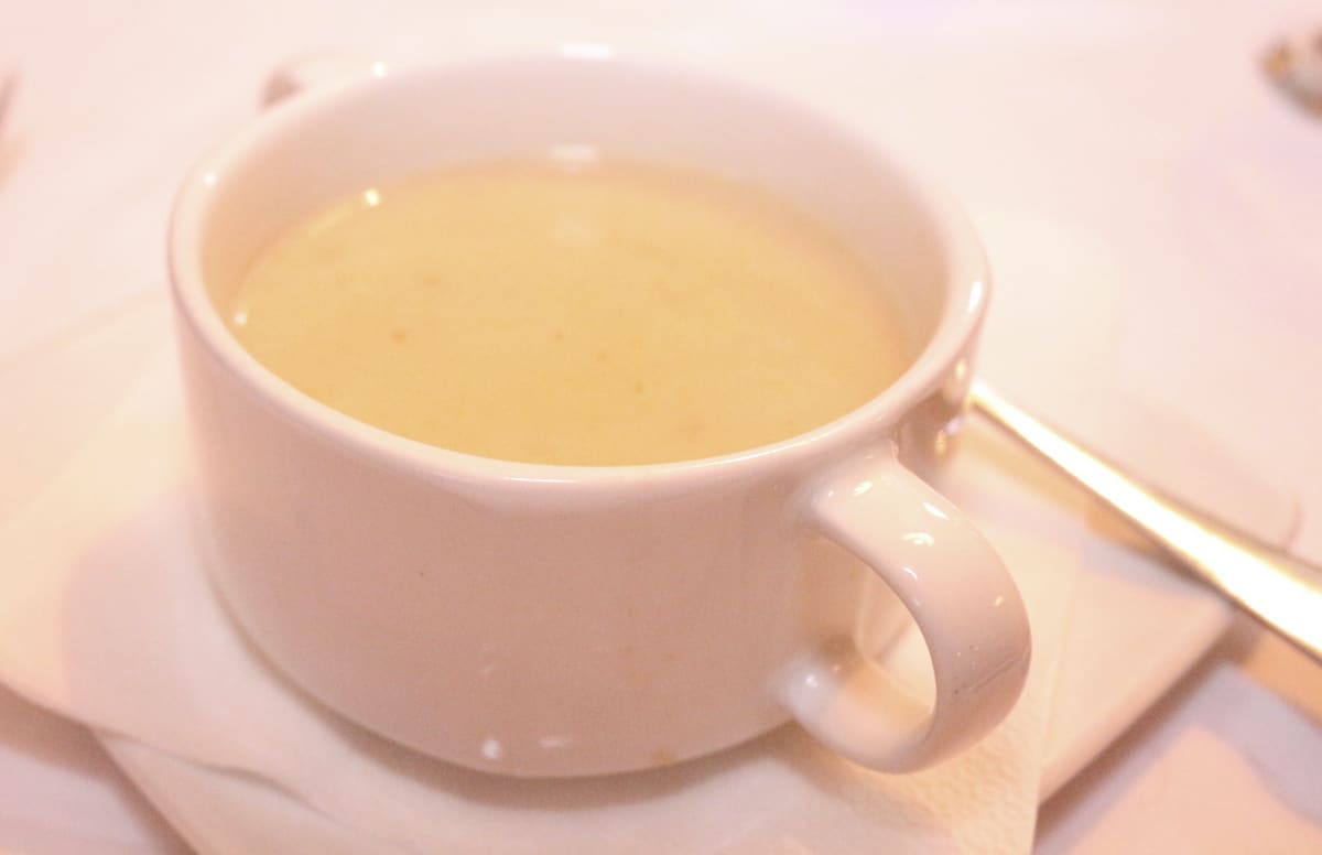 Soup Zalewajka in a white cup.