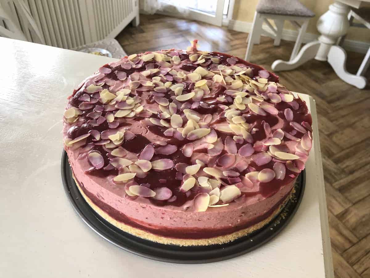 Plum cake with almonds on top.