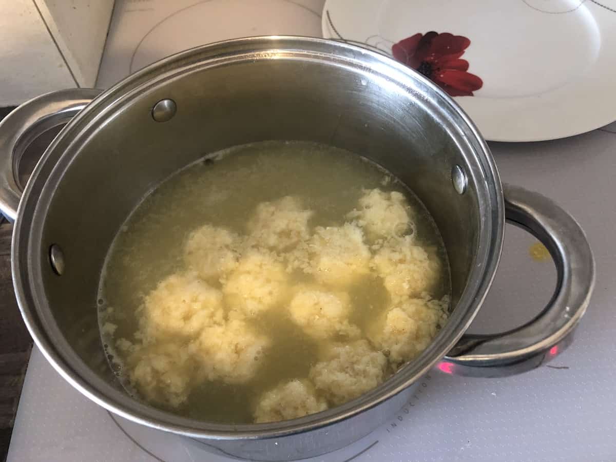 Fish balls cooking in the stock.