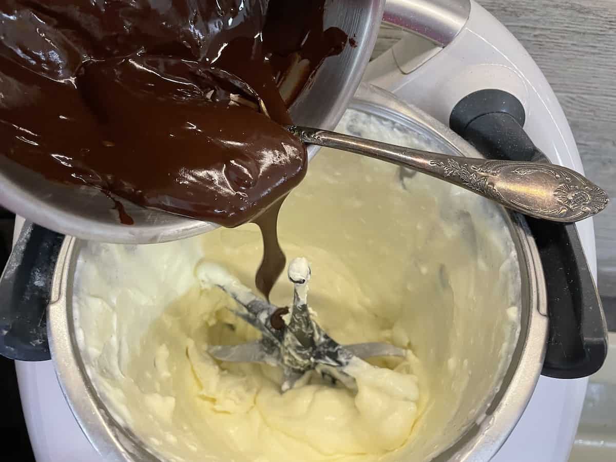 Description: Chocolate ganache being poured into a Polish Easter chocolate mazurek.