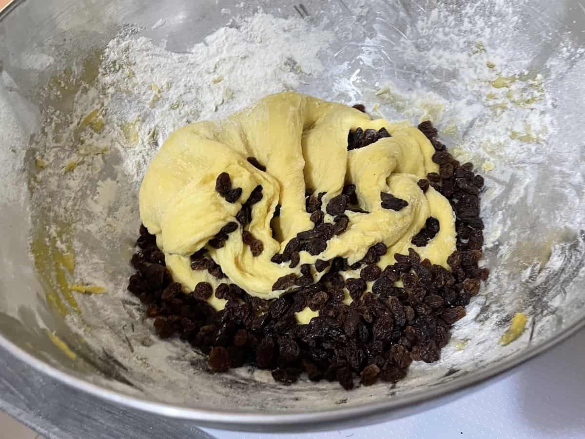 Raisins and dough in a bowl.