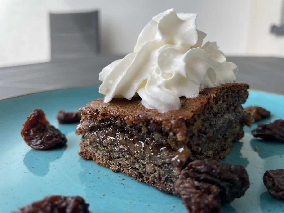 Slice of poppy seed cake on a blue plate.