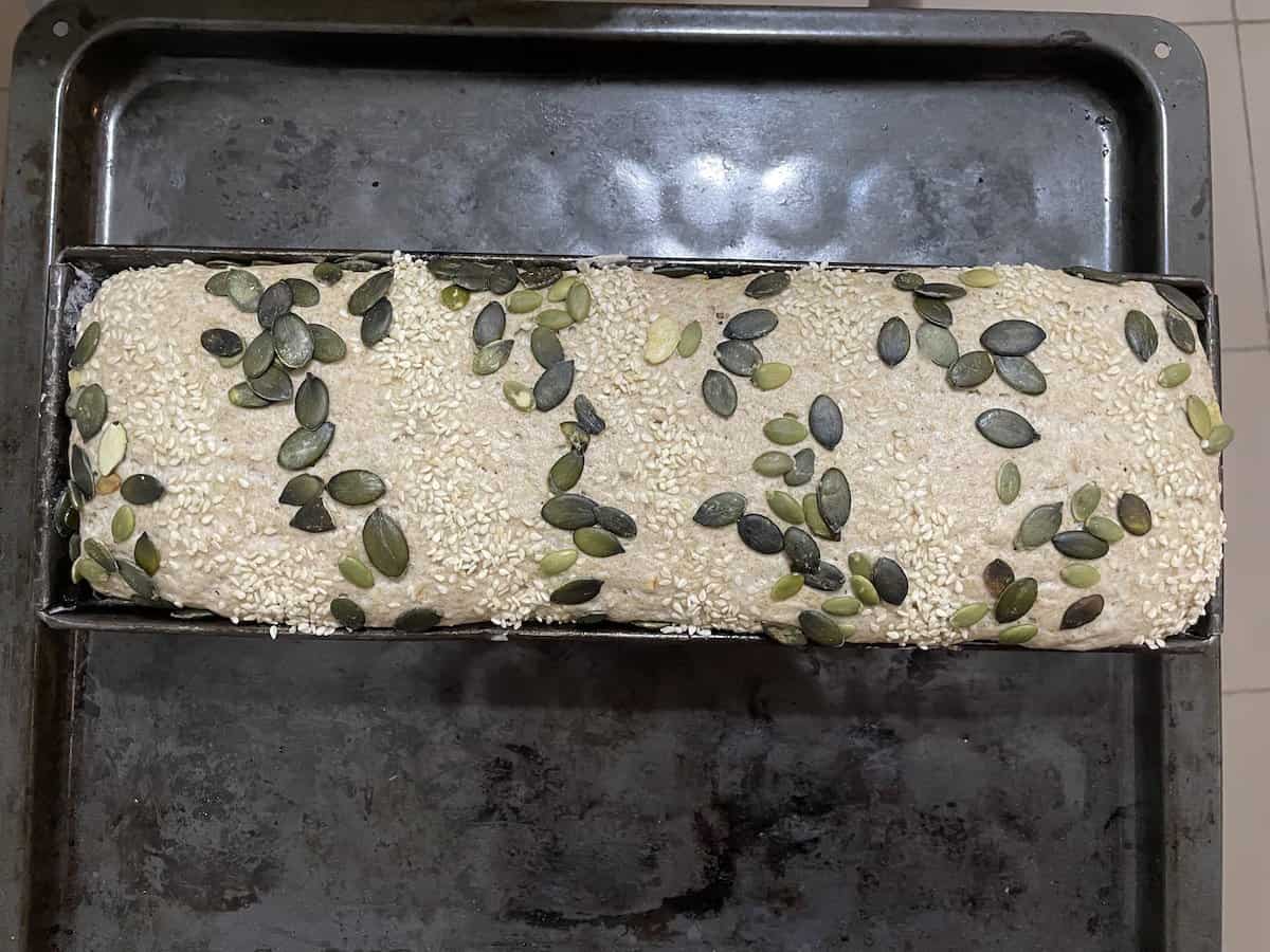 Cover the dough with pumpkin seeds.