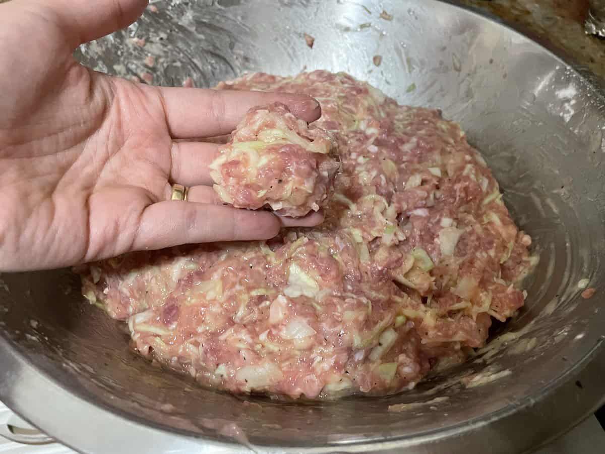 Mix the ingredients for the Polish cabbage meatball recipe well.