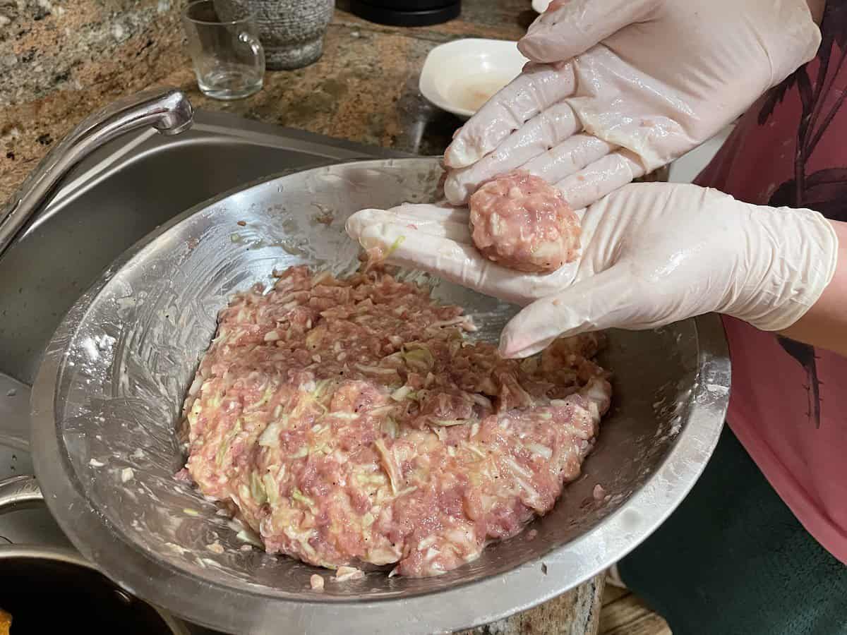 Forming the cabbage meatballs.