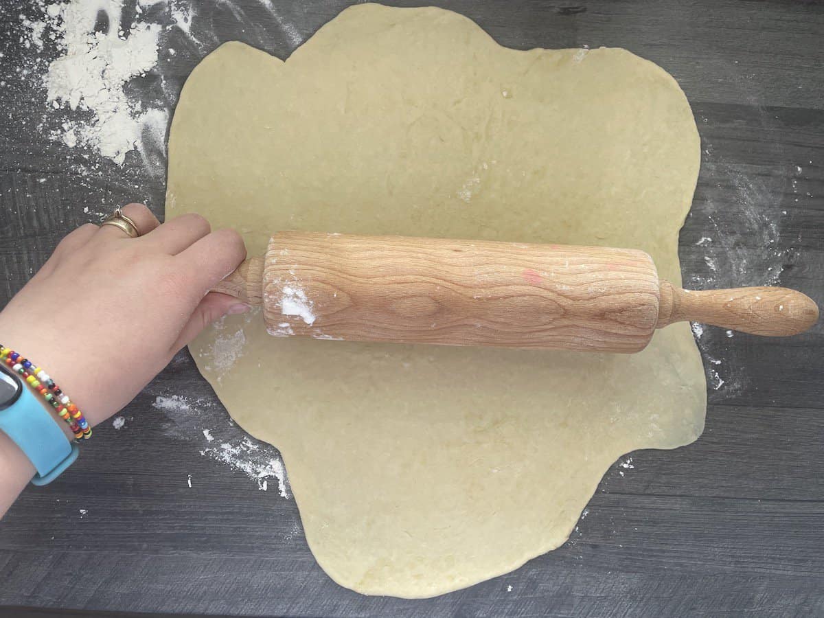 Roll the dough on a floured surface.