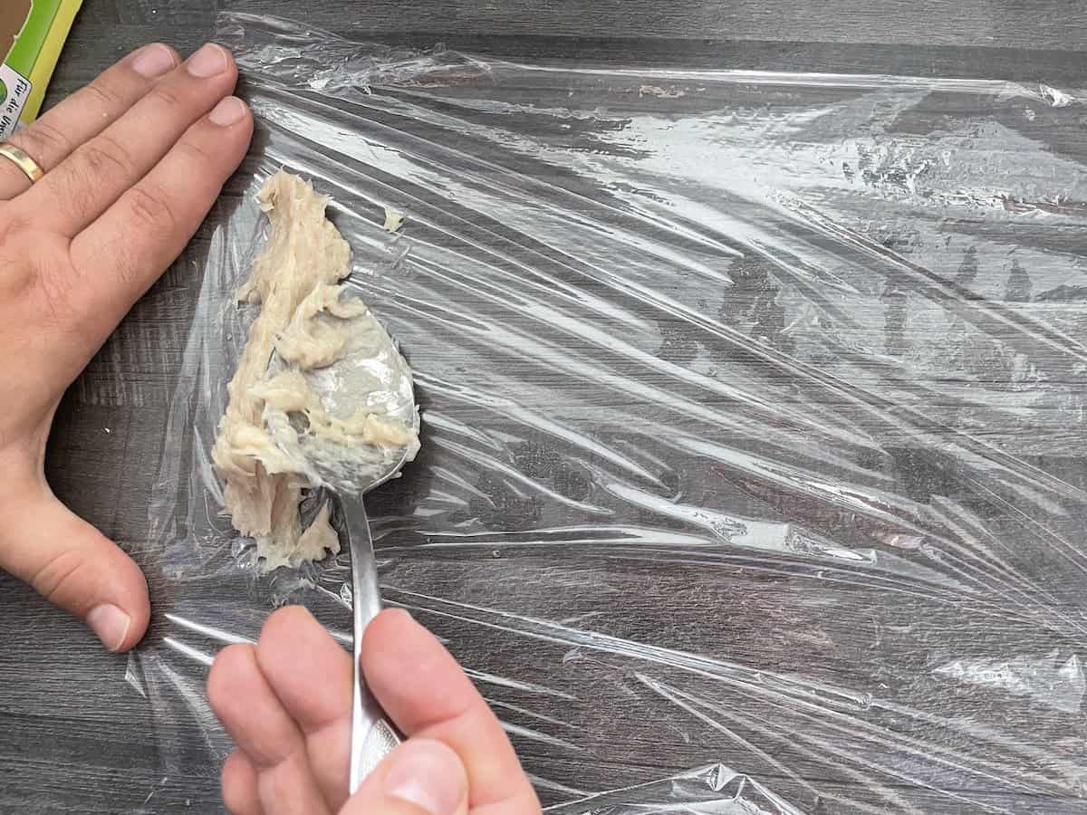 Add the meat on to the cling wrap.