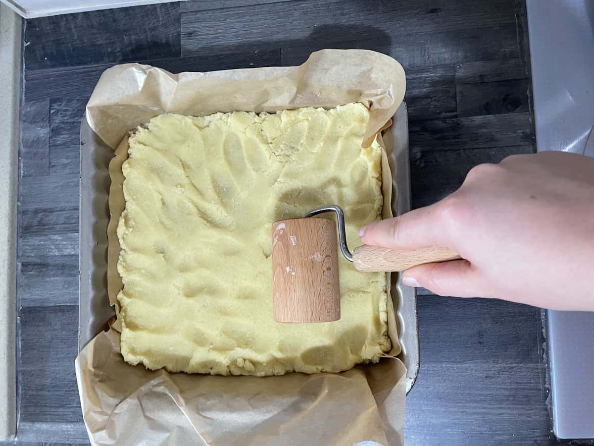 Use a pizza roller to flatten the dough.