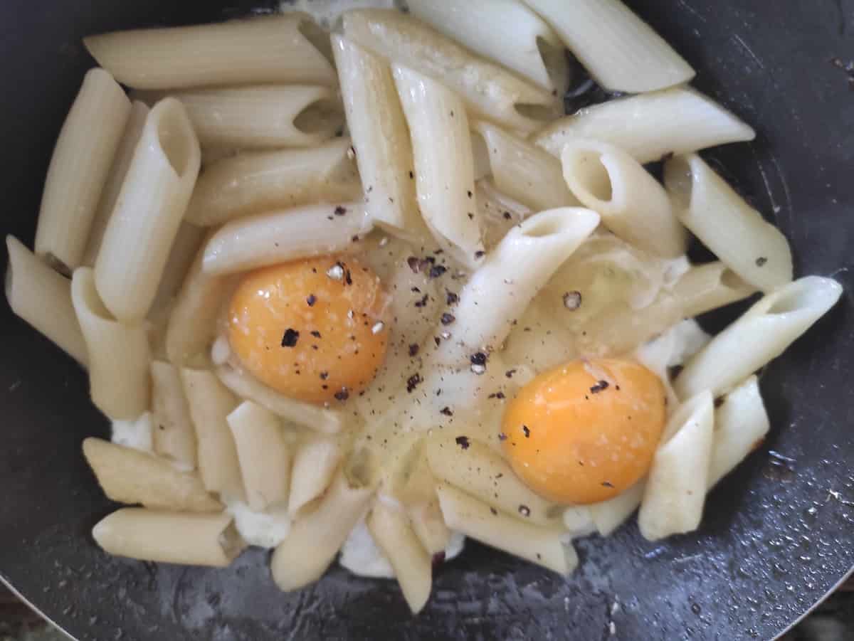 Eggs and pasta in a dish.