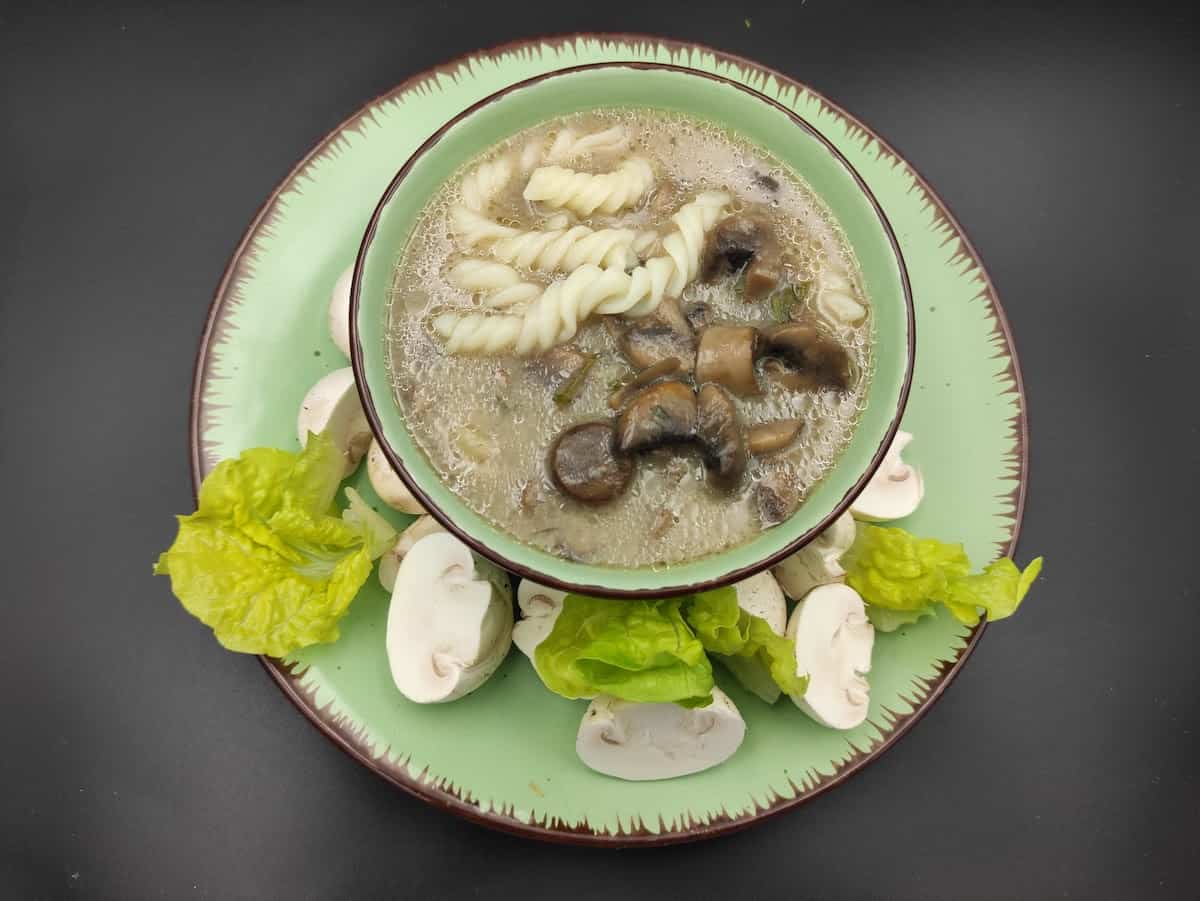 Zupa pieczarkowa in a green bowl.