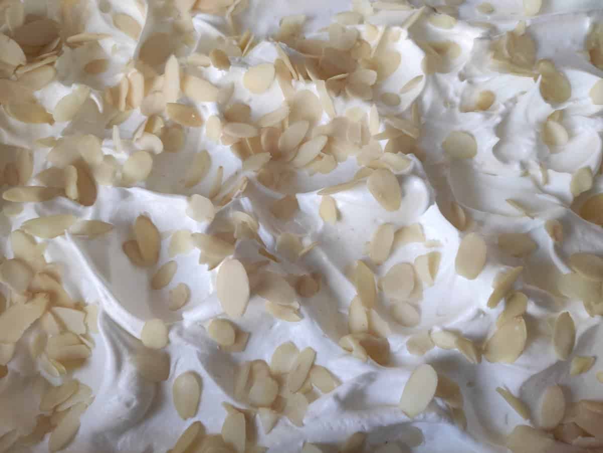 Egg white mix layer topped with sliced almonds.