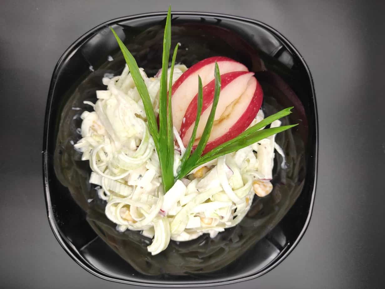 Salatka z pora in a black bowl.