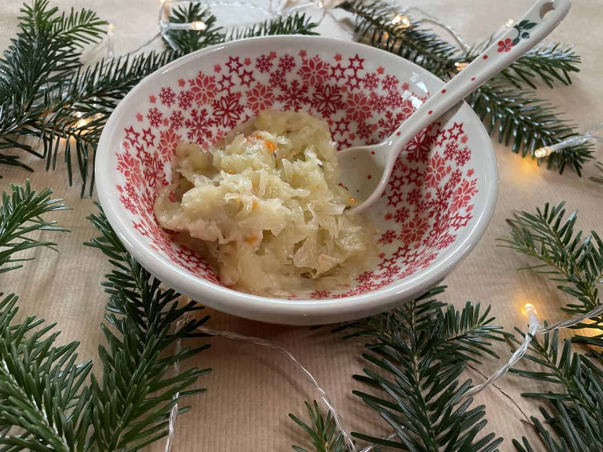 A bowl of fried cabbage on a table.